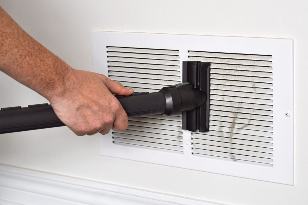 rsz 1person s hand vacuuming dirty return air vents 2023 11 27 04 51 47 utc